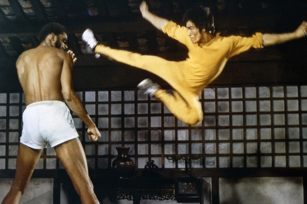 Bruce Lee doing a dragon kick at Kareem Abdul-Jabbar. A screen cap from the movie "Game of Death"